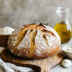 Freshly baked sourdough discard bread with slices showing its airy crumb and soft texture.