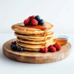sourdough-discard-pancakes-stack Sourdough discard pancakes with maple syrup and fresh berries.