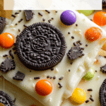 Easy White Chocolate Halloween Oreo Bark Treat 4 White chocolate Oreo bark topped with festive Halloween candies for Halloween Snacks And Desserts 2