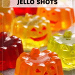 Halloween Jello Shots That Wow Guests 4 Halloween Jello Shots in bright red with festive decorative toppers on a table. 2
