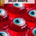 Playful Red Halloween Jello Shots with Eyeball Twist 4 Red jello shots with edible eyeballs arranged in clear cups over festive napkins. 2