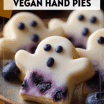 Vegan Blueberry Ghost Hand Pies with Lemon Icing 4 Mini ghost shaped blueberry hand pies with lemon glaze on a fall themed plate 2