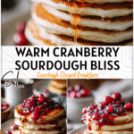 Fluffy Sourdough Pancakes with Warm Cranberry Sauce for the Perfect Holiday Breakfast 5 Stack of cranberry sauce pancakes topped with warm syrup and fresh cranberries on a holiday table.