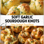 Soft golden sourdough garlic dough knots brushed with butter and herbs on a baking sheet.